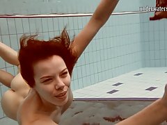 Katya Okuneva is slowly taking off her clothes in the swimmi...
